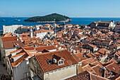 View from defensive Walls of Dubrovnik, Old Town of Dubrovnik city, Croatia, with Saint John Fortress on left and Lokrum Island.