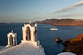 View to the Caldera from Oia town with the white bell towers of a church in the foreground, Santorini, Cyclades Islands, Greek Islands, Greece, Europe.