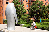 France, Rhone, Lyon, the Cite Internationale designed by the architect Renzo Piano, Velo'v bike passing by a sculpture by Xavier Veilhan showing a Penguin