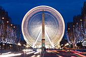 France, Paris, area listed as World Heritage by UNESCO, Champs Elysees avenue illuminated for Christmas, the great wheel and the obelisk of the Concorde square