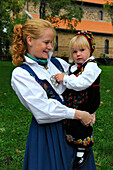 Norway, Oslo, family with Bunad traditional outfit going to the mass at Gamle Aker kirke