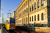 Hungary, Budapest, old buildings along the quay of the Danube river listedlisted as World Heritage by UNESCO at Pest and tram passageway