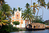 India, Kerala State, Allepey, Backwaters Region, houseboat in front of catholic church
