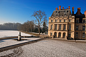 France, Seine et Marne, Fontainebleau, the Royal Castle, listed as World Heritage by UNESCO, the cour de la fontaine (courtyard of the fountain) and etang des carpes (carps pond) frozen under the snow