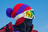 Canada, British Columbia, Whistler, young snowboarder with his bonnet and golden glasses