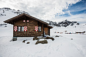 Traditional wooden chalet and snowy winter landscape, Melchsee-Frutt, Canton of Obwalden, Switzerland