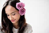 Mixed Race woman with roses in hair
