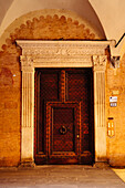 Ornate door with knocker in Bologna, Emilia-Romagna, Italy
