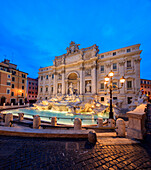 Panorama of Trevi Fountain illuminated by street lamps and the lights at dusk, Rome, Lazio, Italy, Europe
