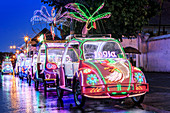 Brightly coloured illuminated pedal cars in Yogyakarta city, Java, Indonesia, Southeast Asia, Asia