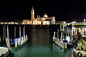 The island and church of San Georgio Maggiore at night with a boat dock in the foreground, Venice, UNESCO World Heritage Site, Veneto, Italy, Europe