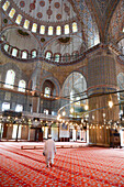 Blue Mosque interior, UNESCO World Heritage Site, mullah in foreground, Istanbul, Turkey, Europe