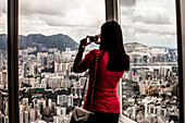Tourist taking picture of Hong Kong's Kowloon district