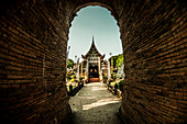 Temple in Thailand with a brick arched gateway