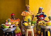 Women in traditional costume selling fruit in Cartagena, Colombia, South America