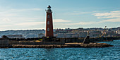 A lighthouse on the Mediterranean coast, Naples, Campania, Italy