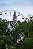 Pfingstmarkt (Pentecost market) fair with ferris wheel on Ederwiesen with Liebfrauenkirche church Frankenberg (Eder), Hesse, Germany, Europe