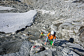 Man and woman descending on fixed-rope route from Richterspitze, Richterspitze, Reichenspitze group, Zillertal Alps, Tyrol, Austria