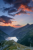 Mood of clouds above barrier lake Zillergrund, from hut Plauener Huette, Reichenspitze group, Zillertal Alps, Tyrol, Austria