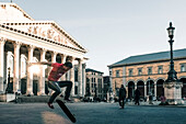 Skateboarder in front of the Residenz Theater in Munich, Bavaria, Germany