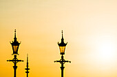 2 alte Lampen und der Fernsehturm als Silhouette im Sonnenuntergangslicht, Hamburg, Deutschland