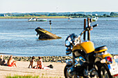 Locals and tourists at the beach in Blankenese with the ferry to Cranz im Alte Land, Hamburg, Germany