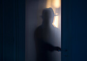 Silhouette of Mysterious Man Opening Door