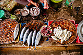 High angle view of vendor cleaning fish