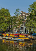 Boat on urban canal, Amsterdam, Holland