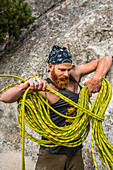 Caucasian man winding rope