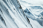 Young male skier riding apart the slopes through the deep powder snow, Gudauri, Mtskheta-Mtianeti, Georgia