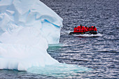 Zodiac raft from expedition cruise ship MV Sea Spirit (Poseidon Expeditions) and iceberg Port Lockroy, Wiencke Island, Graham Land, Antarctic Peninsula, Antarctica