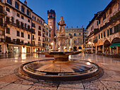 Marketplace Piazza delle Erbe in the historic center of Verona with the fountain of Madonna Verona and the Palazzo Maffei in the background, Veneto, Italy