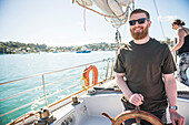 Tourist on a sailing boat trip in the Bay of Islands, from Russell, Northland Region, North Island, New Zealand, Pacific