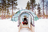 Man sitting inside igloo, Kakslauttanen Igloo Village, Saariselka, Finland, Scandinavia, Europe