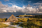 Boathouse and Twr Mawr lighthouse on Llanddwyn Island, Anglesey, Wales, United Kingdom, Europe