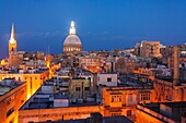 Overview at dusk of illuminated historic city of Valletta, Malta.