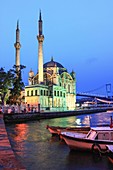 Ortakoy Mosque and Bosphorus Bridge illuminated , Istanbul , Turkey.