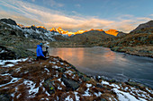 Italy, Trentino Alto Adige, Adamello Brenta Park, Nambrone valley, mountain photographer at work during a dawn at Black Lake.