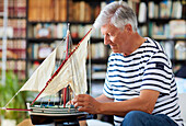 Senior man, 60-70, Building model sailboat, Whaleship, Getaria, Gipuzkoa, Basque Country, Spain, Europe