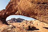 Pontok mountains, seen thorugh a rock arch, Spitzkoppe, Erongo, Namibia.