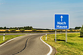Road Sign with the German title Nach Hause (home) on the German Highway (Autobahn), Germany, Europe.