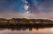 The Milky Way in Sagittarius (toward the galactic centre) going down behind the badland hills along the Red Deer River. I shot this near East Coulee on Highway 10 in Alberta, on an autumn night. Some clouds were drifting through over the exposure times. P