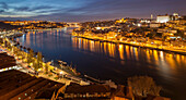 Night falls on river Douro in Porto, Portugal.