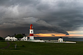 'Souter Lighthouse along the coast under ominous storm clouds; South Shields, Tyne and Wear, England'