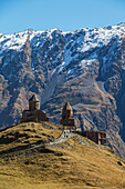 'Gergeti Trinity Church with the Caucasus Mountains in the background; Kazbegi, Mtskheta-Mtianeti, Georgia'
