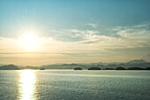 The sun about to set over the mountains surrounding Qiandao (Thousand Islands) Lake, Chunan, Zhejiang, China, Asia