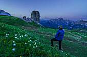 Cinque Torri group, Cortina d'Ampezzo, Veneto, Dolomites, Italy, Woman staring at the sunset