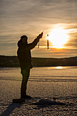 Ice fishing at Limingen Lake Rorvik B+©rgefjell National Park Tr+©ndelag Norway Europe