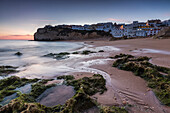 Sunset on the village perched on the promontory overlooking the beach of Carvoeiro Algarve Lagoa Faro District Portugal Europe